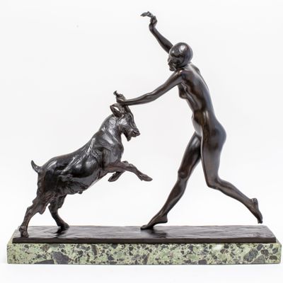an image of a statue of a woman playing with a bull