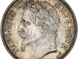 a close up of a coin with a man ' s face on it