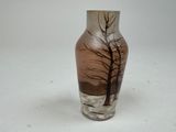 a vase that has a picture of a tree on it