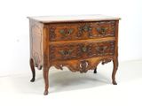 a small wooden chest of drawers with a marble top