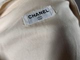 a close up of a chanel label on a white shirt