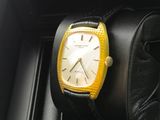 yellow and black watch sitting on a black case in a black box