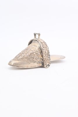 an image of a pair of silver shoes on a white surface