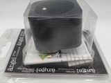 a small black object in a plastic container on top of a table