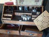 an old wooden cabinet with a lot of bottles and glasses in it