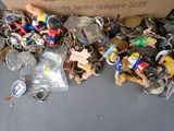 a box full of assorted key chains on the floor