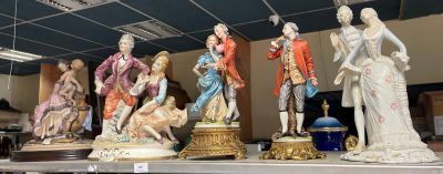 many figurines that are on a shelf in a store