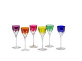 four different colored wine glasses sitting next to each other on a white surface