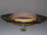 a bowl on a stand with a handle on it
