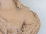 a statue of a woman that is sitting on a table