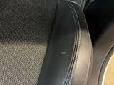 the seat of a car with a black leather trim and a black seat cushion