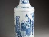 a blue and white vase with a picture of people on it
