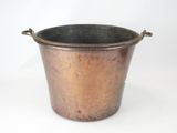 a small copper pot with a handle on a white background