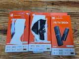 three boxes of nintendo wii remotes sitting on a wooden surface