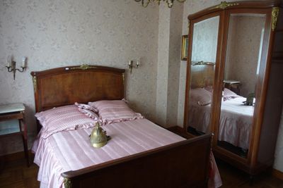 a bed with a pink comforter in a bedroom