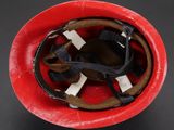 a close up of a red helmet on a table