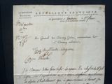 an old document with writing on it on a black surface