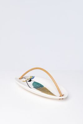 a white plate with a blue bird on it and a gold rim