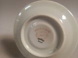 a white plate with a red and black design on it