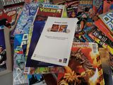 a pile of comic books sitting on a table