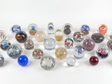 a lot of glass marbles that are on the table