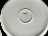 a white plate with a green writing on it