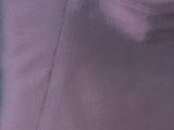 the back of a woman ' s purple dress with buttons on it