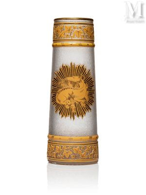 a glass vase with a gold design on it