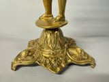 a gold statue of a man standing on top of a pedestal