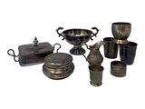 a lot of silver items that are sitting on a table