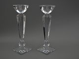 pair of crystal candlesticks on stand on grey background