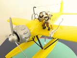 a small toy airplane with a pilot on top of it