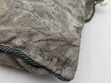 a small bag with a rope around it on a white surface