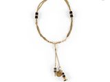 a gold and black necklace with two charms on a white background