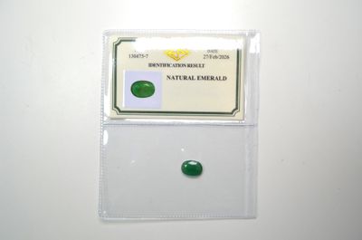 a close up of a piece of green jade on a white surface