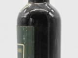 a bottle of beer sitting on a white surface