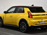 the rear end of a yellow suv parked in a room