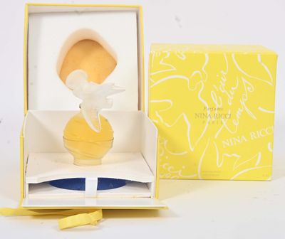 a small figurine of a woman in a yellow dress in a yellow box