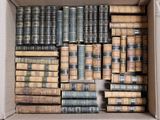 a box full of old books sitting on the floor