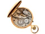 a gold pocket watch with gears on it