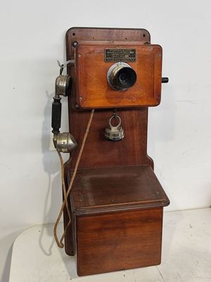 an old fashioned telephone that is sitting on a table