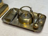 a silver tray with a tea kettle and a spoon on it
