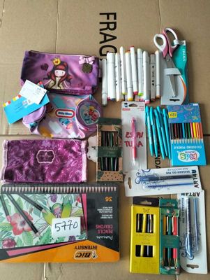 many school supplies laid out on the floor next to each other