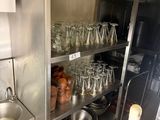 many glasses on the shelves in the kitchen