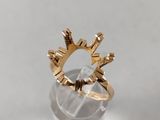 a close up of a gold ring sitting on top of a glass ball