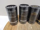 three cans of macarona sitting on top of a wooden cutting board
