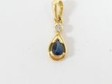un pendentif en or orné d'une pierre bleue en forme de larme et d'un diamant