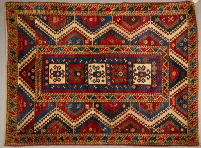an old rug with a red, blue, and yellow design