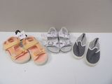 three pairs of baby shoes are lined up on a table