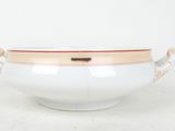 an image of a white bowl with a gold rim and handles